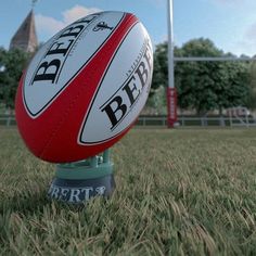 a rugby ball sitting on top of a green field