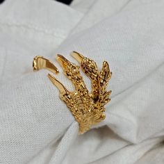 Show off your edgy style with our fabulous Gold Dragon Claw Ring! Designed meticulously to portray dragon claws, this unique piece of gothic jewelry is sure to make an impression. This extraordinary gold-toned rim is an open ring, making it fully adjustable to fit anyone. Ideal for those who love punk or biker aesthetics, this ring can also make a marvelous gift. Flaunt your unique sense of style with this intriguing Dragon Wrap Ring! Product Description - Material :- 925 Sterling Silver/Alloy S Dragon Claws, Gothic Dragon, Faberge Jewelry, Vintage Inspired Rings, Claw Ring, Dragon Claw, Style Gothic, Dragon Ring, Gold Dragon