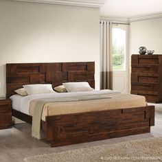 a bedroom with a bed and dressers in it