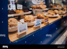 various baked goods on display in a bakery shop window - stock image, food and drink