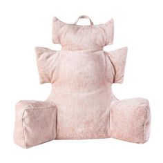 a pink chair with pillows on it and an ottoman in the shape of a pillow