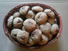 a basket filled with cookies sitting on top of a table next to a white wall