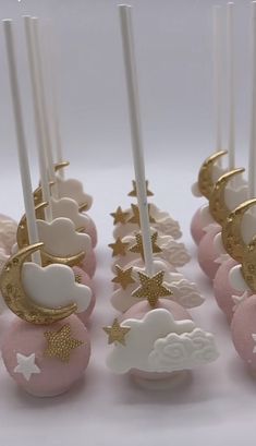 there are some cake pops with candles in the shape of clouds and stars