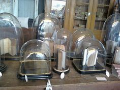 there are many glass domes on the table