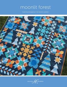 the cover of moonlit forest quilt book, featuring an image of a blue and orange quilt