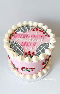 a pink cake with white frosting and decorations on top that says dancing queen among sweet only