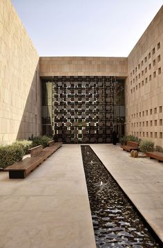 an empty courtyard with benches and water feature