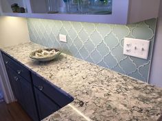 a bowl sitting on top of a counter next to a wall mounted light switch box