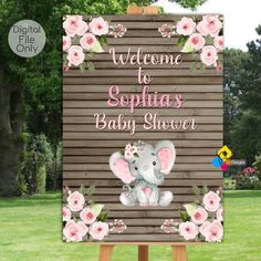 a wooden sign with an elephant and flowers on it that says welcome to sophiias baby shower