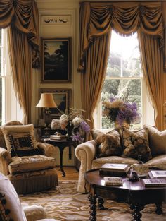 a living room filled with lots of furniture next to a window covered in drapes