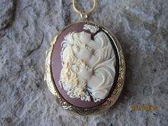 "Beautiful cameo locket The locket is victorian style with beautiful scroll on the front and back, 2\" long. It can hold two photos and/or treasured keepsakes Pass down from generation to generation The chain is 24\" 1.2mm gold plated snake chain with a lobster claw clasp Perfect for Brides or Bridal parties. Makes a unique memorable gift for any occasion Timeless classic look, both casual or formal Thanks so very much for looking and please do visit my shop Lisa" Handmade Victorian Locket Necklace For Memorial, Victorian Cameo Locket Necklace As A Gift, Vintage Collection Cameo Medallion Locket Necklace, Vintage Collection Medallion Cameo Locket Necklace, Vintage Medallion Cameo Locket Necklace, Antique Cameo Necklace As Keepsake, Antique Cameo Necklace For Keepsake, Antique Cameo Necklace Keepsake, Cameo Medallion Locket Necklace Keepsake