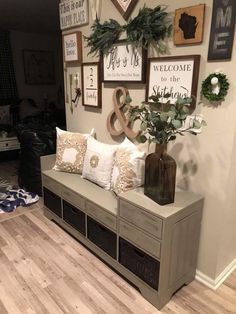 a living room filled with furniture and lots of pictures hanging on the wall above it