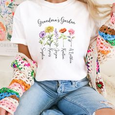 a woman sitting on the ground wearing crochet gloves and a t - shirt that says grandma's garden