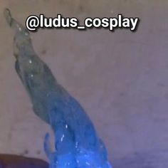 a blue toothbrush is being held up by someone's hand with the words oudus cosplay on it