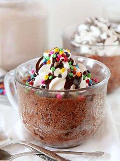 two desserts in glass bowls with sprinkles on top