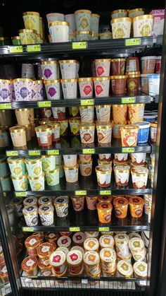 there are many ice creams on display in the store case and one is filled with them