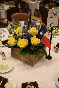 a table topped with plates covered in cake and flowers next to a sign that reads 26