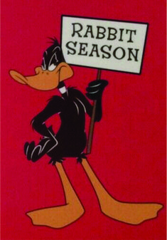 a cartoon character holding a sign that says rabbit season