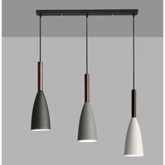 three lights are hanging from the ceiling in a room with grey walls and flooring