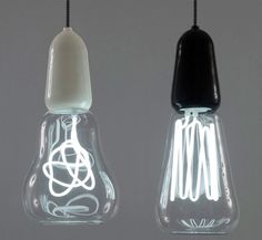 three light bulbs hanging from the ceiling in different shapes and sizes, with one bulb turned upside down