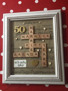 a framed scrabble art piece with the words married and 50 years old