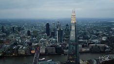 an aerial view of the city of london, england at night with skyscrapers and other tall buildings