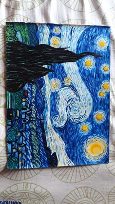 the starry night painting is displayed on a white sheet with blue and green designs