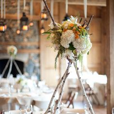 an image of a table setting with flowers in the center and candles on the side