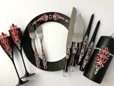 a black and white table setting with red accents