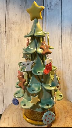 a ceramic christmas tree with ornaments on it