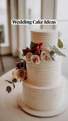 a white wedding cake with flowers on top