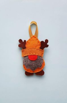 an ornament shaped like a reindeer hanging on a string