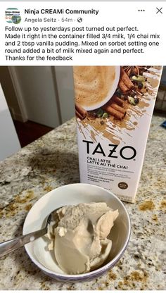 a white bowl filled with tazo next to a carton of milk on top of a counter