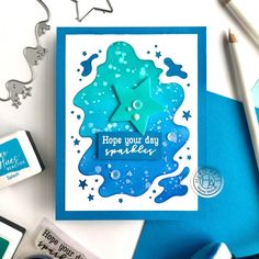 a blue card with a star on it next to some crafting supplies and scissors