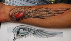 an arm with wings and a heart on it