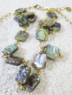 "Michelle Roy Gold Leaf and Multi Color Ammolite Gemstone Double Necklace with gift box The gold necklace measures 19.5\". The ammolite necklace measures 16\"." Elegant Gold Necklace With Abalone Shell, Elegant Gold Jewelry With Abalone Shell, Elegant Gold Abalone Shell Jewelry, Gift Shell Necklace With Lobster Clasp, Handmade Gold Jewelry With Abalone Shell, Elegant Abalone Shell Necklace As Gift, Elegant Abalone Shell Necklace For Gift, Gold Shell Necklace Gift, Gold Shell Necklace For Gift