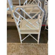 a white chair sitting on top of a carpeted floor