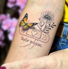 a woman's arm with a butterfly and flowers on it