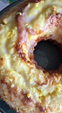 a glazed doughnut sitting on top of a pan covered in icing and toppings