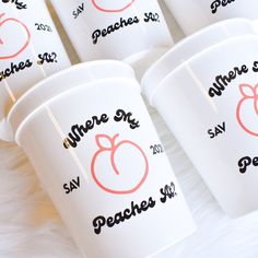 six white cups with peaches on them are sitting on a furnishing area