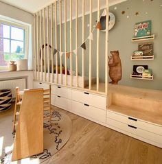 there is a bunk bed in the room with white drawers and shelves on the wall