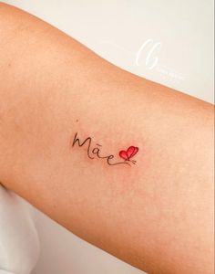 a woman's arm with the word love written in cursive writing on it