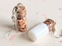 a jar filled with cookies and corks next to a keychain