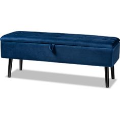 an upholstered blue bench with black legs