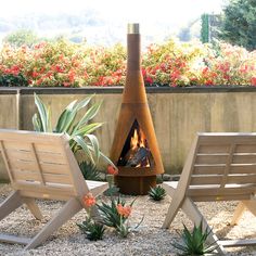 two lawn chairs sitting in front of an outdoor fireplace