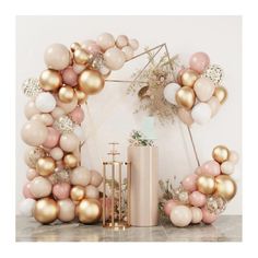 the balloon arch is decorated with gold, pink and white balloons