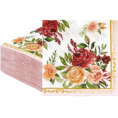 two napkins with flowers on them sitting next to each other