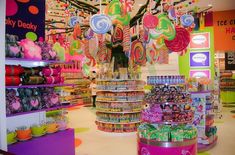 a candy store with lots of colorful candies and lollipops hanging from the ceiling