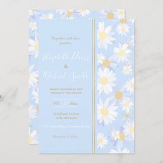 a blue and yellow wedding card with daisies