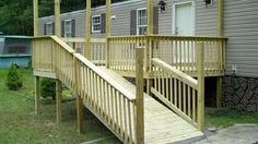 a wooden porch with stairs leading up to a house